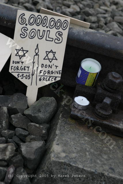 Gedenkschildchen am Gleis des KZ Auschwitz: "6.000.000 Souls - Don't forget - Don't forgive" mit Kerze und Davidstern